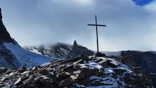 Close up Christian Catholic religious Jesus Christ Cross rocky glacier mountain top drone aerial Saa