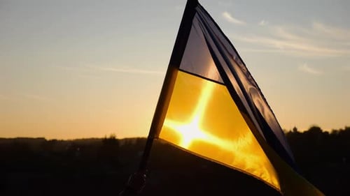 Ukrainian Flag Waving at Beautiful Golden Sunset