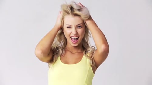 Excited woman playfully posing with blonde curly hair
