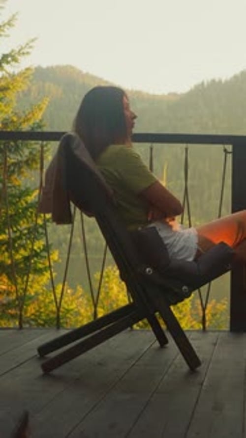 Young Woman Alone Enjoys Freshness of Summer Nature on Terrace