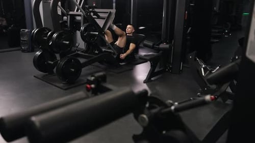 Sportsman Uses Leg Exercise Machine Gym Workouts