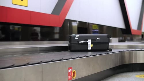 Suitcase on Airport Conveyor Belt Moving