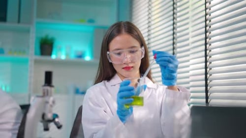 Asian female scientist working in biotechnology research laboratory.