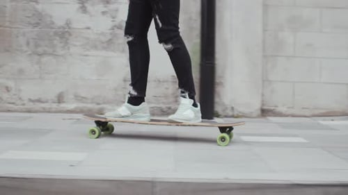Portrait of Stylish Teenage Young Guy Riding on the Skateboard Outdoor Teenager with a Skate Board