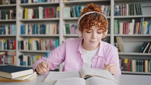 Woman Studying in Library with Headphones