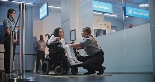 Security Agent Assists Traveler in Wheelchair at Airport