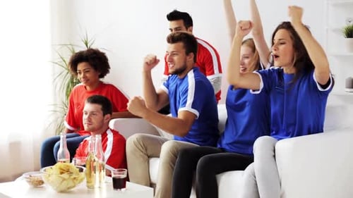 Friends Enjoying a Game and Food on Couch