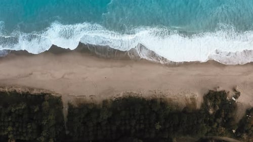 Top View of a Coastline with Crashing Waves