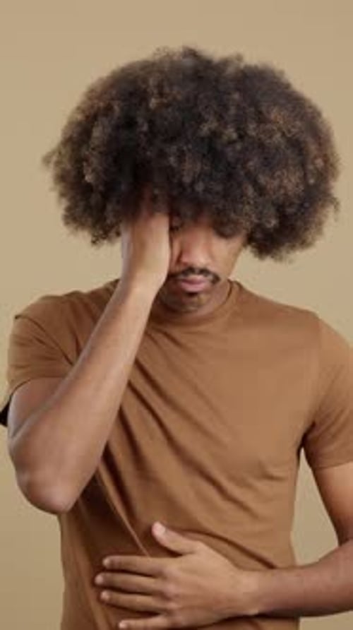 Man Gesturing and Expressing Headache and Stomachache