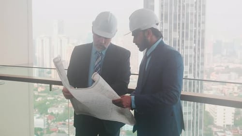 Architects Examining Plans in Modern Urban Office