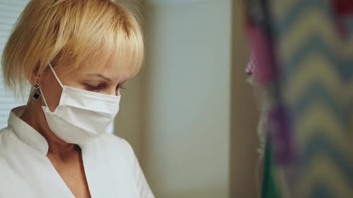 Female Nurse in Protective Mask Working in Hospital Neonatal Resuscitation