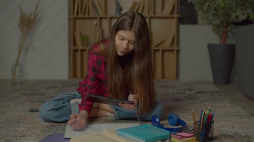 Teenage Girl Studying at Home with Tablet