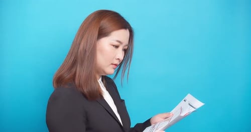 Businesswoman checking and analyzing graph report for a management plan to the success company