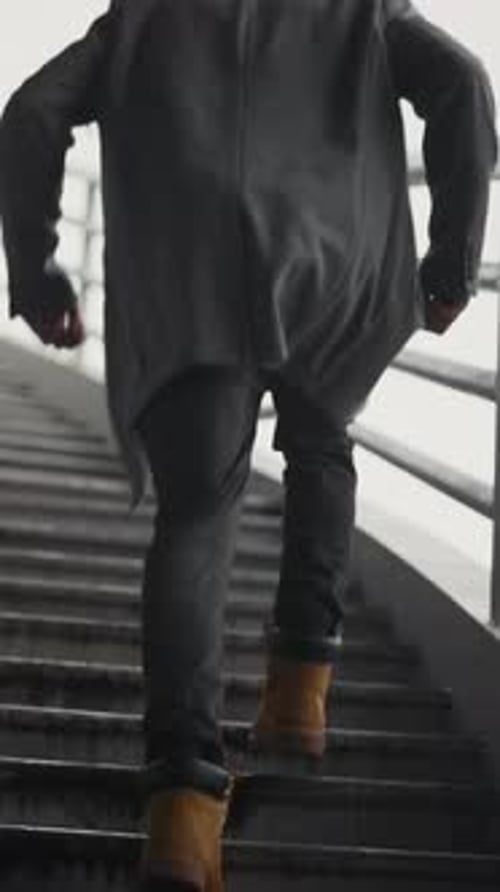Young Black Man Running Up Over Outdoors Stairs Back View Slow Motion Walk in City in Autumn Day