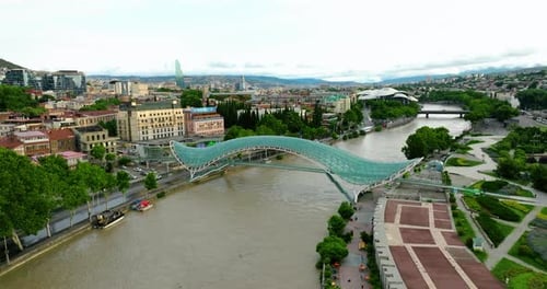 Bridge of Peace, Contemporary Glass Bridge Over The Mtkvari River In Tbilisi, Georgia. Aerial Drone