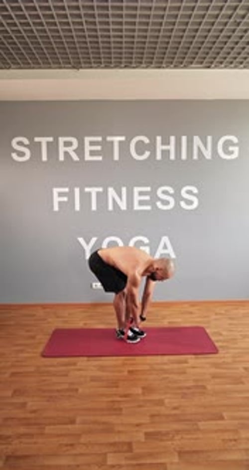 The Trainer Shows the Correct Execution of the Exercise for the Back