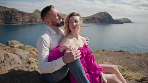 Couple Embracing on Cliff Overlooking Tranquil Ocean in Madeira