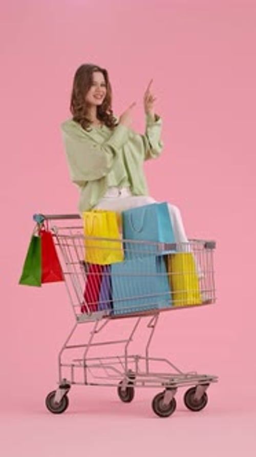 Happy Woman Sitting in Shopping Cart