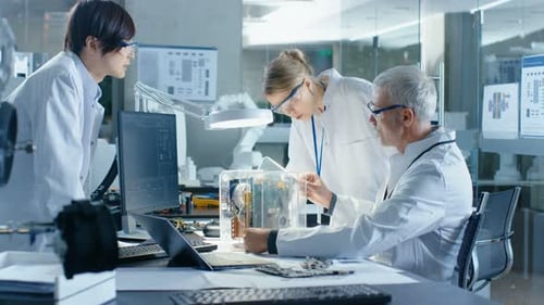 Team of scientists analyzing equipment in laboratory