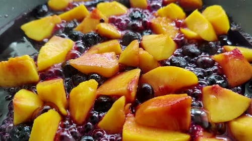 Sauteed Peaches and Blueberries Cooking in Pan