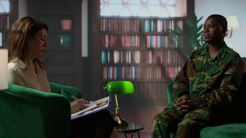 Counselor Interviewing Man in Camouflage Uniform Indoors