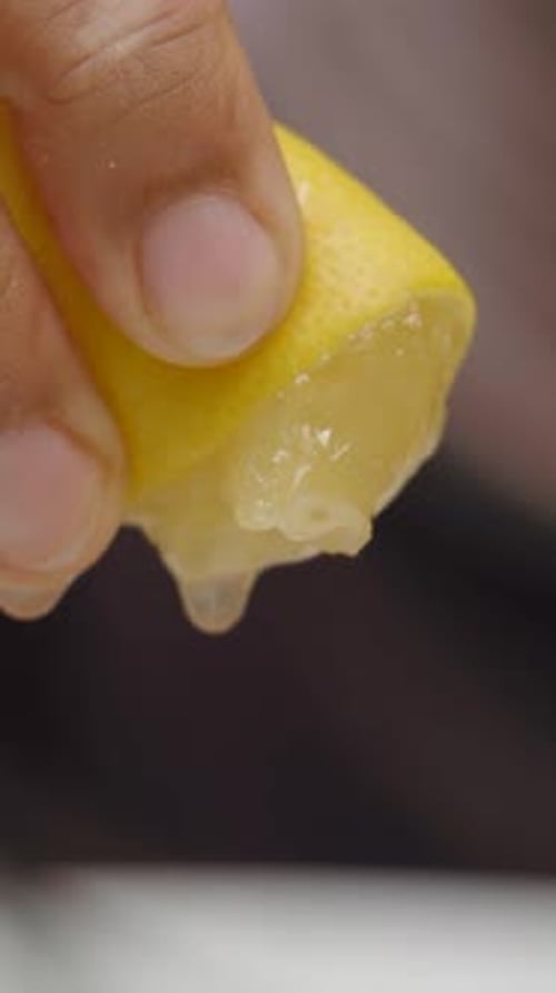 Squeezing Refreshing Lemon Slice to Extract Juice