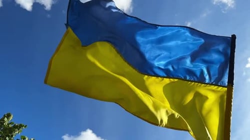 Ukrainian Flag Waving Against Blue Sky