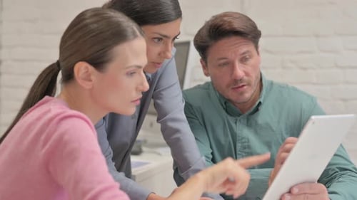 Close up of Creative People Discussing Work on Tablet
