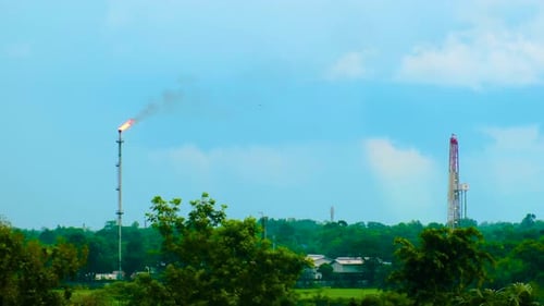 Fire on flare stack at oil and gas central processing platform, pollution concept, Bangladesh