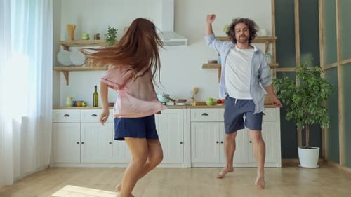 Lovely Couple Having a Fun Together While Dancing at the Bright Kitchen
