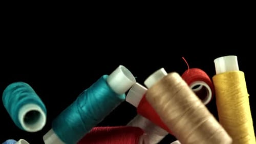 Multicolored Threads Fly on a Black Background Filmed on a Highspeed Camera at 1000 Fps