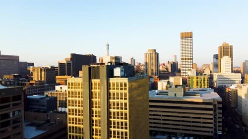 A beautiful slow rising shot of the city of Johannesburg being revealed from a building in Braamfont