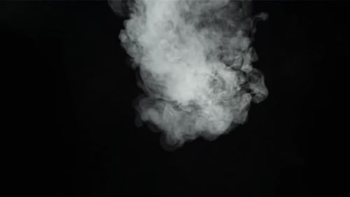 Rising White Smoke Against Black Background