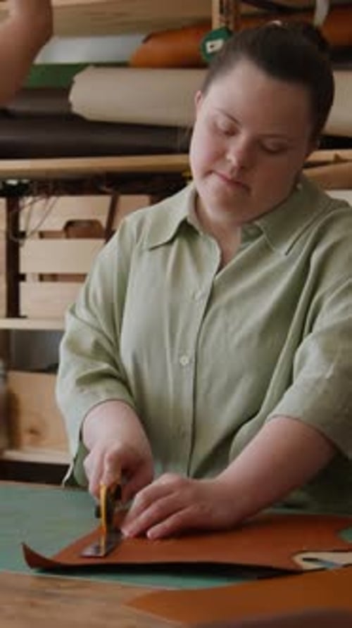 Woman Cutting Leather in Workshop