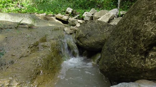 Waterfall Flowing Through Natural Rocks in a Tropical Forest