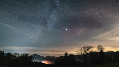 Milky Way Galaxy Stars is Slowly Covering by Clouds Over Countryside
