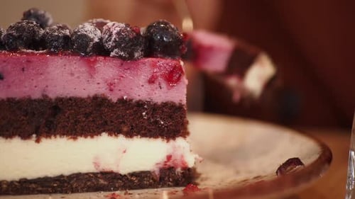 Delicious Layered Berry Cake Being Cut Close-Up