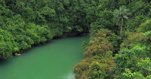 Turquoise River Flowing in Natural Canyon with Lush Tropical Forest