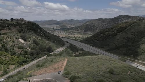 Scenic Aerial View of Highway Through Green Hills