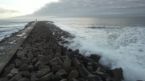 Waves Crashing Against a Rocky Breakwater