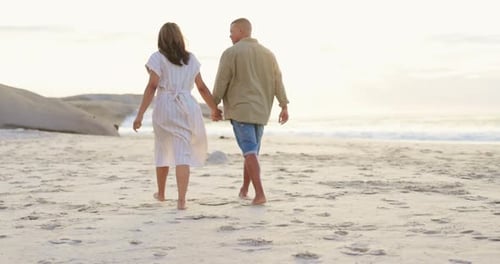 Walking, love and holding hands with couple on beach for romance, bonding and travel at sunset