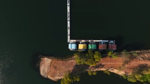 Aerial View of a Pier in Chonburi Mountain Thailand with Colorful Cabins Extending Into a Calm Lake
