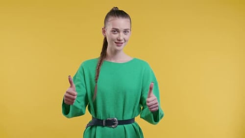 Young Woman Gives Two Thumbs Up Approvingly