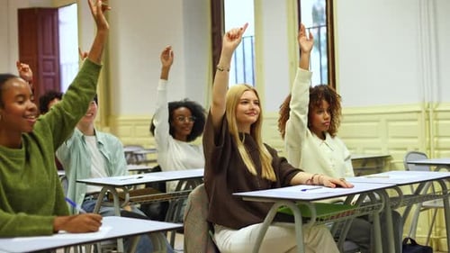 University Students Raising Hands and Answering a Question in a Classroom