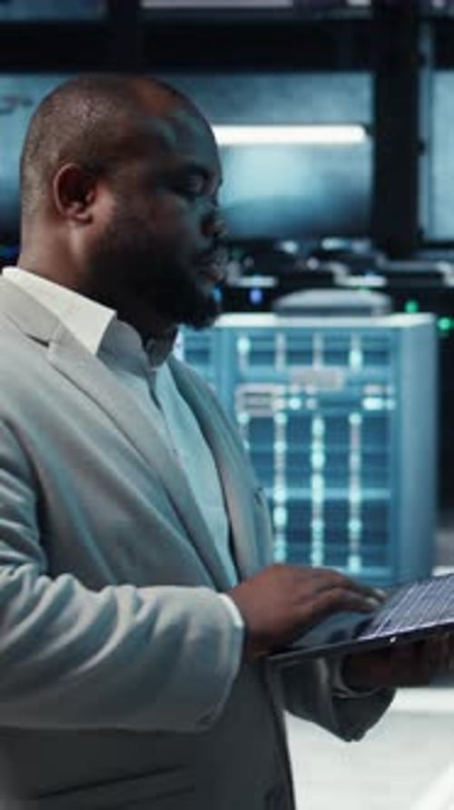 IT Man Typing in Server Room