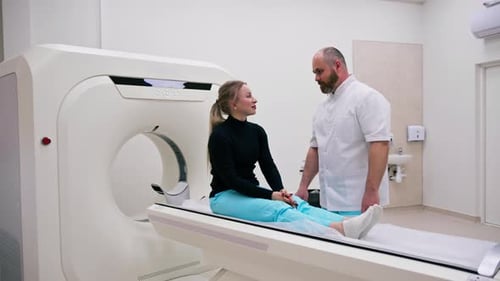 A doctor consults a patient in a medical clinic before an X-ray computed tomography procedure
