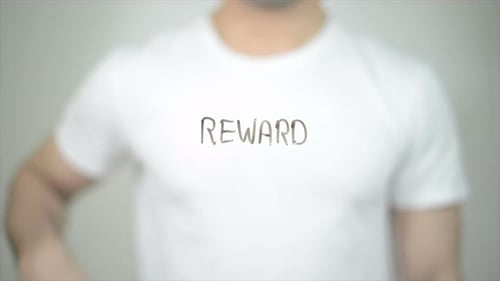 Writing the Word Reward on Clear Surface