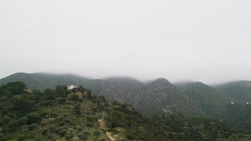 Beautiful mountains with massive fog above, aerial drone view