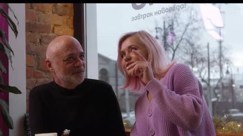 Beautiful Elderly Couple is Chatting in Cafe Stock Footage Elderly Couple is Chatting Sweetly on