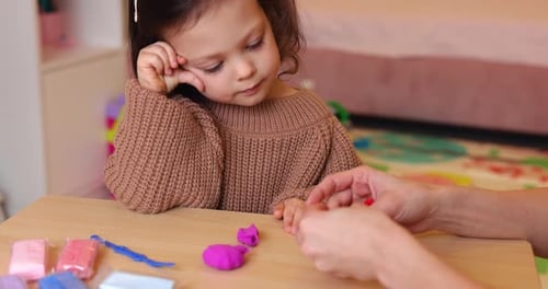 Adorable Child Plays with Clay at Home